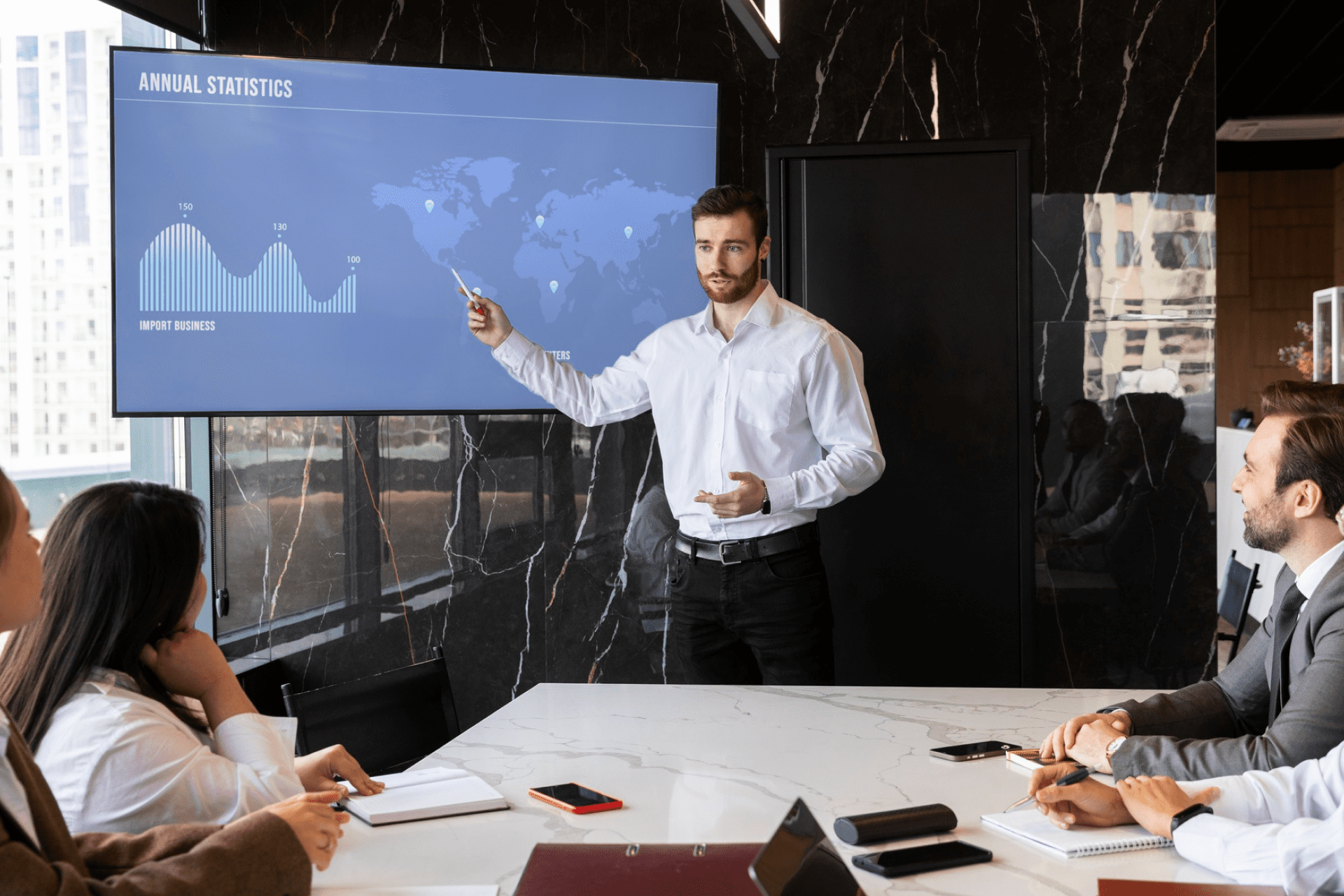 Talking profit and loss in the boardroom. an executive giving a presentation on a projection screen to a group of colleagues in a boardroom.